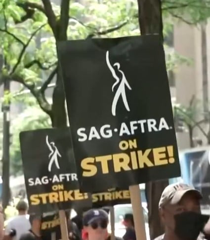 workers holding strike signs